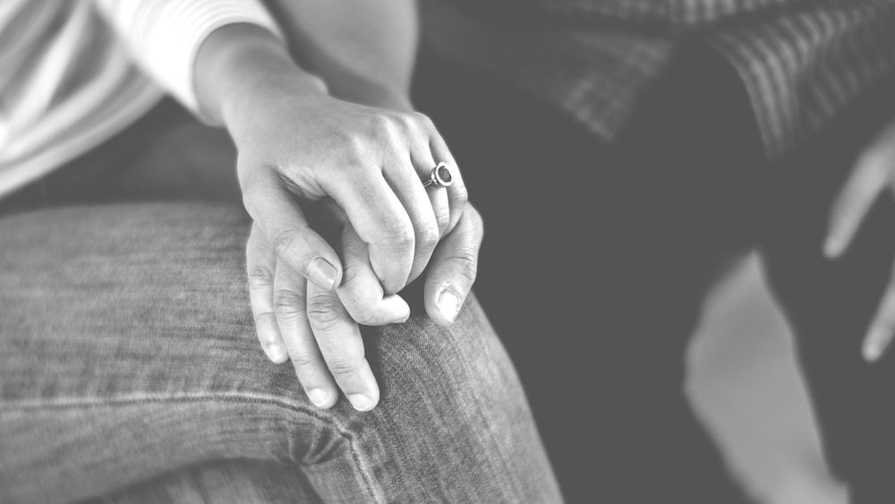 Closeup of couple holding hands