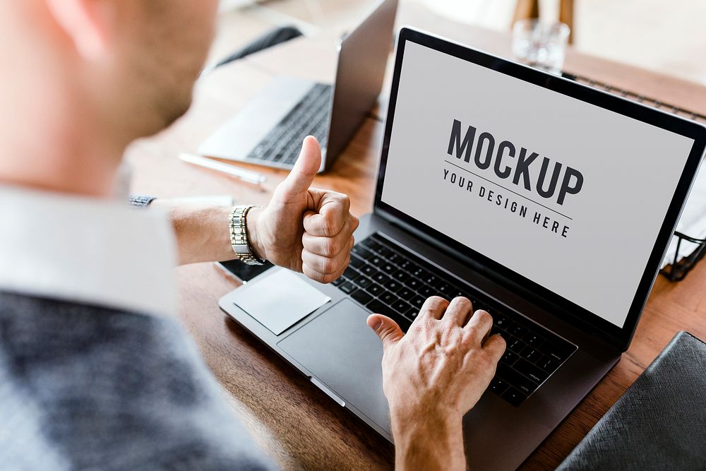 Businessman thumb up using laptop mockup