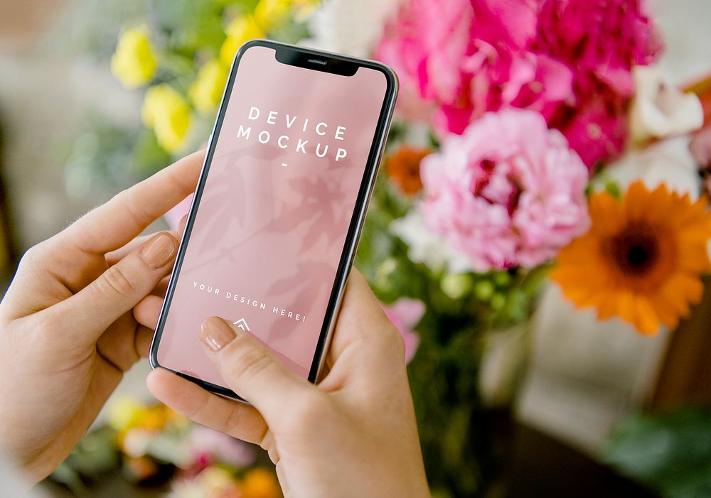 Woman using a mobile screen mockup by the flowers