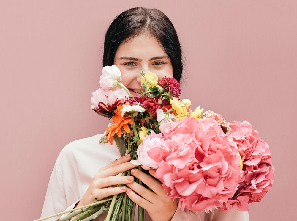 Beautiful young girl with a large pink bouquet