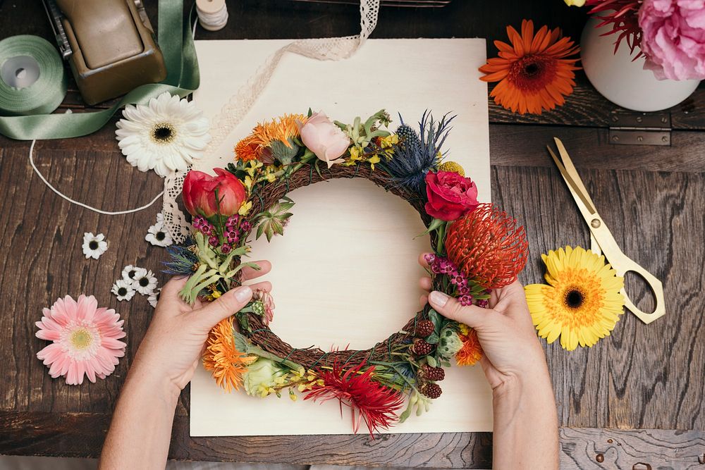 Woman making a floral midsummer wreath