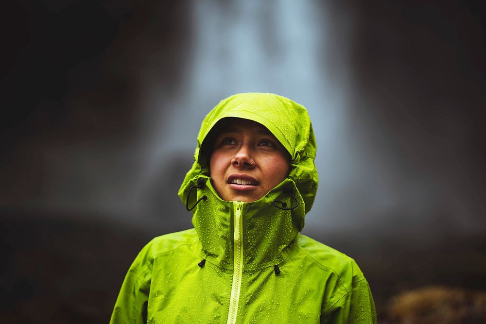 Woman in a green jacket at the Haifoss waterfall, Iceland