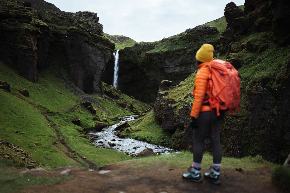 Female hiker with a view of Kvernufoss waterfall in South Iceland