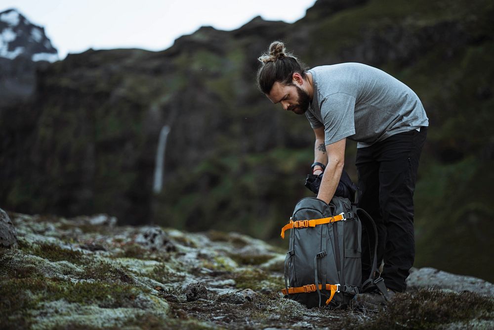Male hiker packing his bag