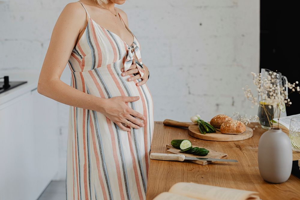 Pregnant woman cooking in a kitchen
