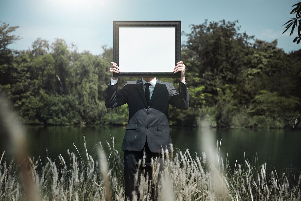 Businessman holding a picture frame