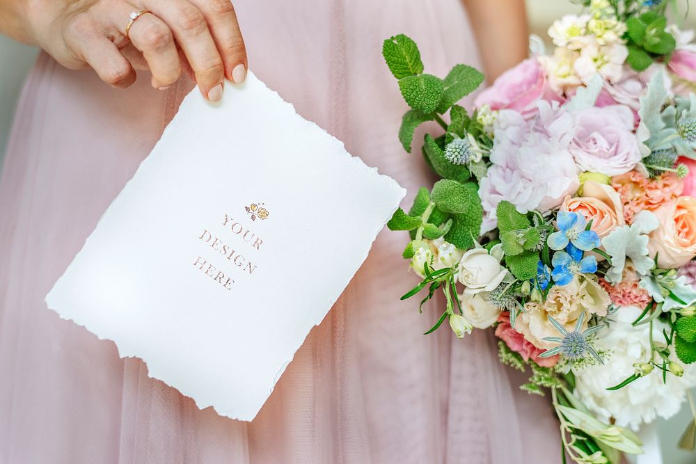 Bride holding a card mockup with a bouquet of flowers