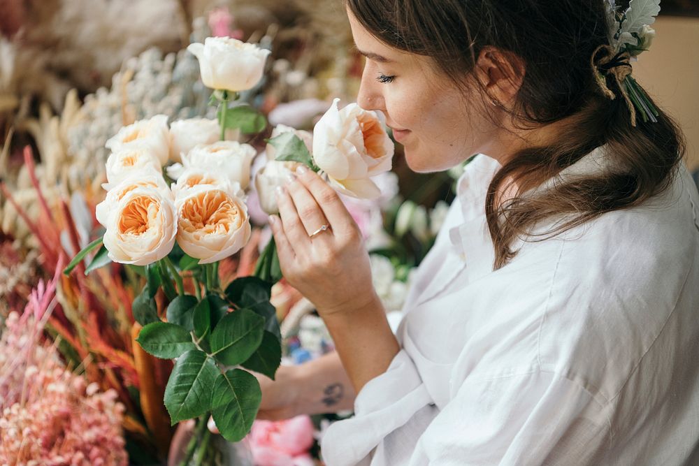 Woman smelling a bouquet of Romantic Vuvuzela Roses.