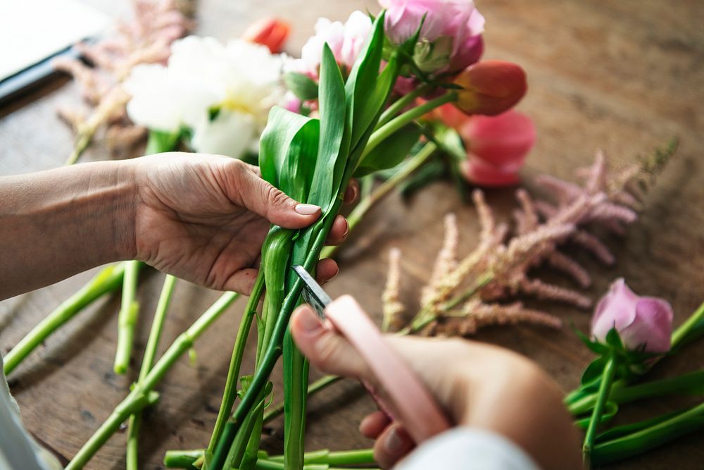 Woman preparing and arranging flowers