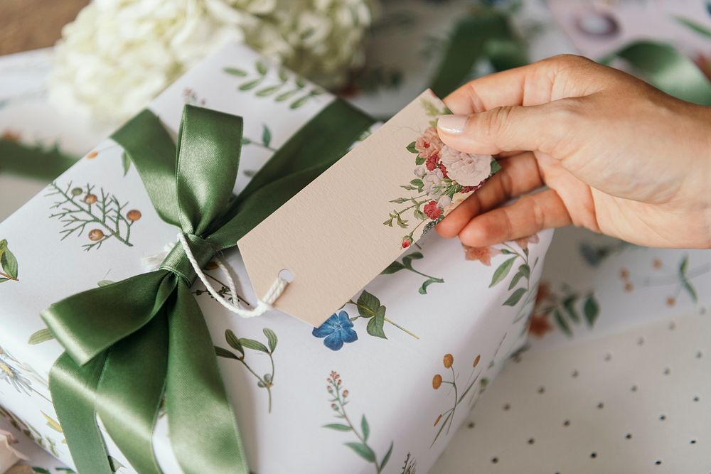 Gift box wrapped with floral patterned paper with a card mockup