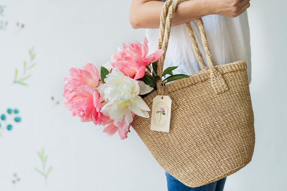 Beautiful peonies in a wicker bag