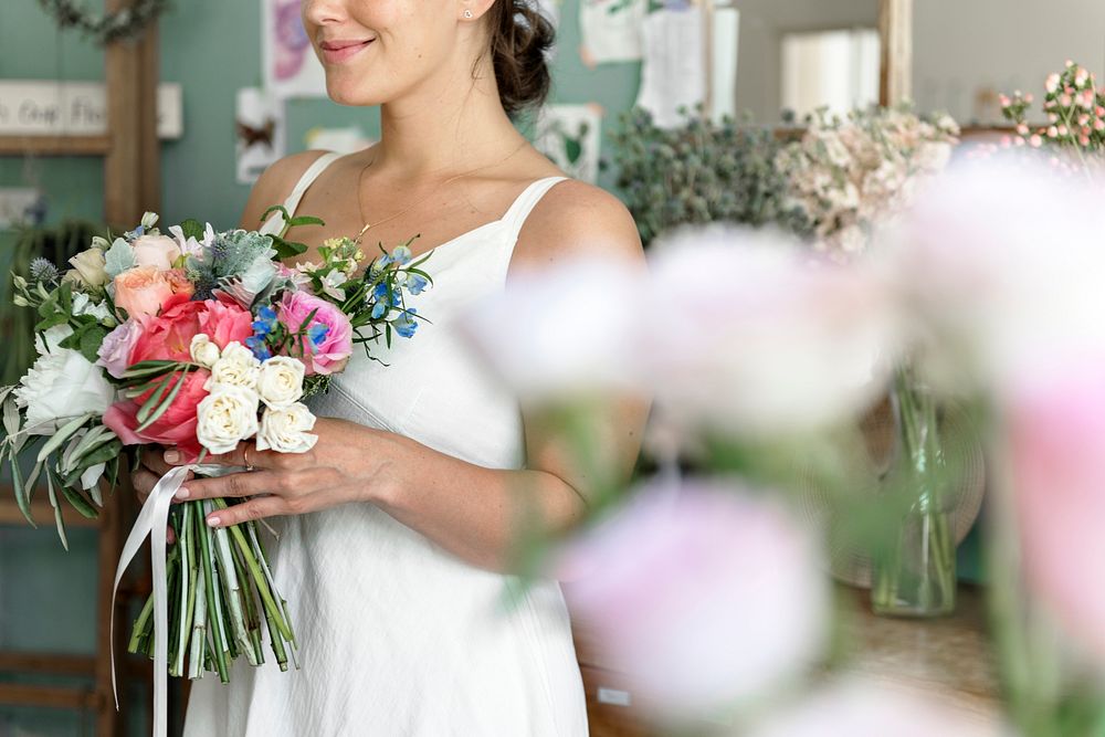 Bride carrying a beautiful flower bouquet