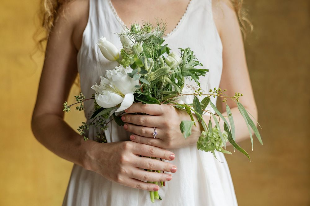 Woman holding a bouquet of white flowers