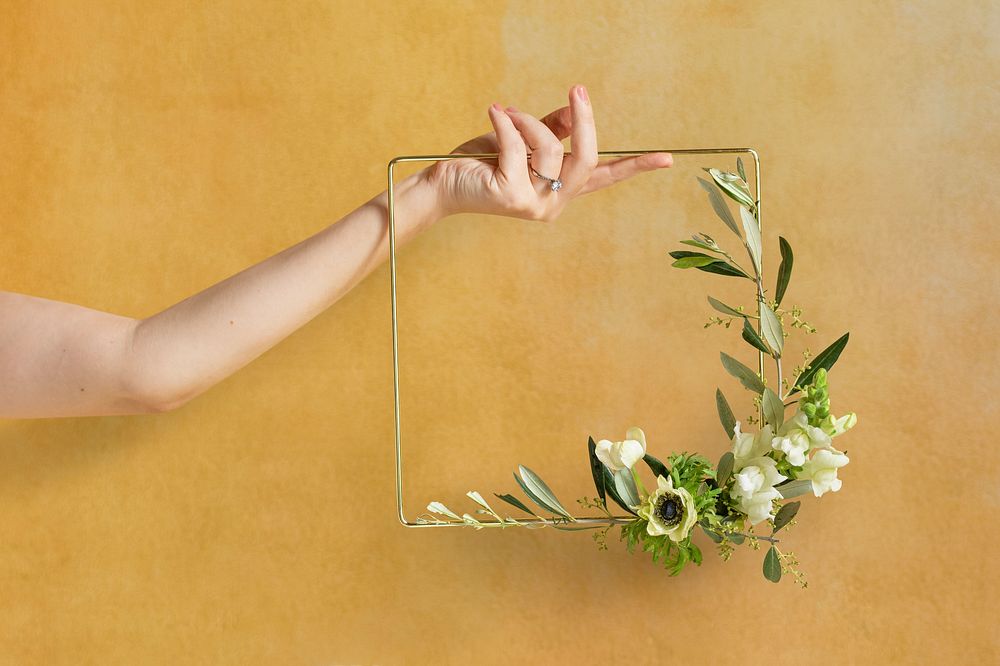 Girl holding a leaf decorated square golden frame