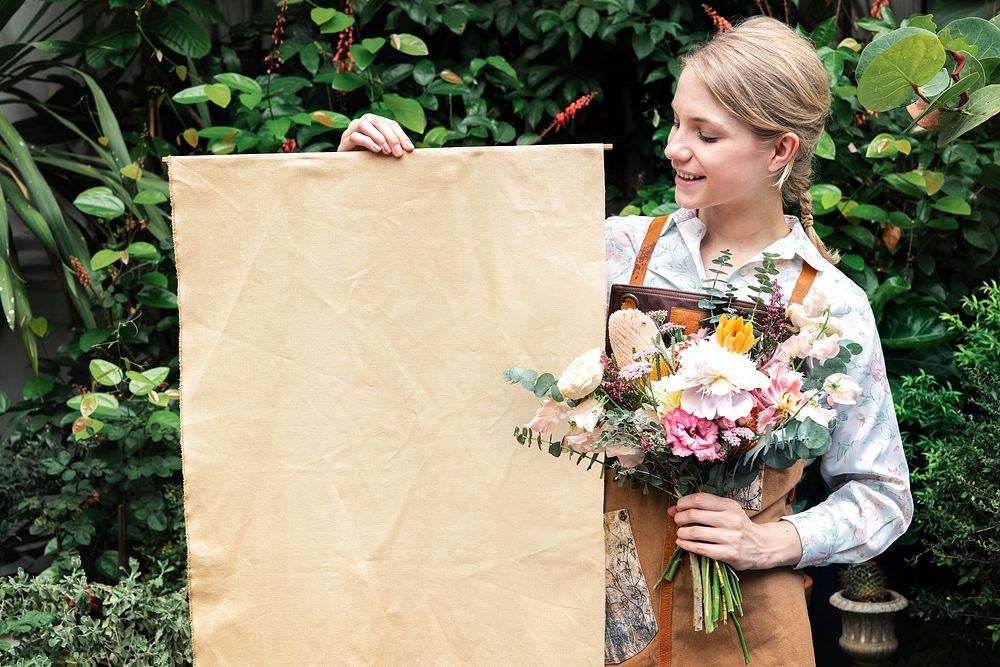 Woman holding a bouquet with a poster