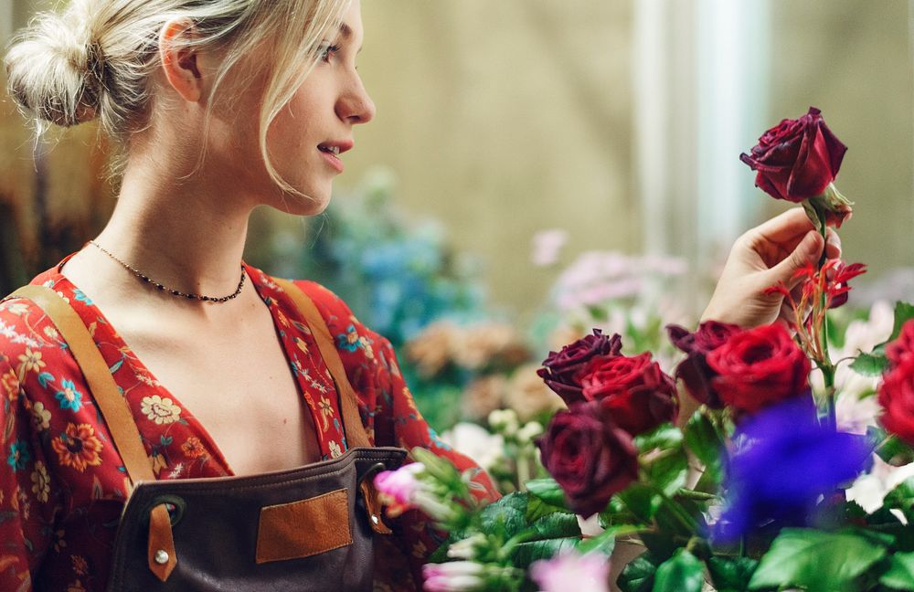 Florist arranging roses in her shop