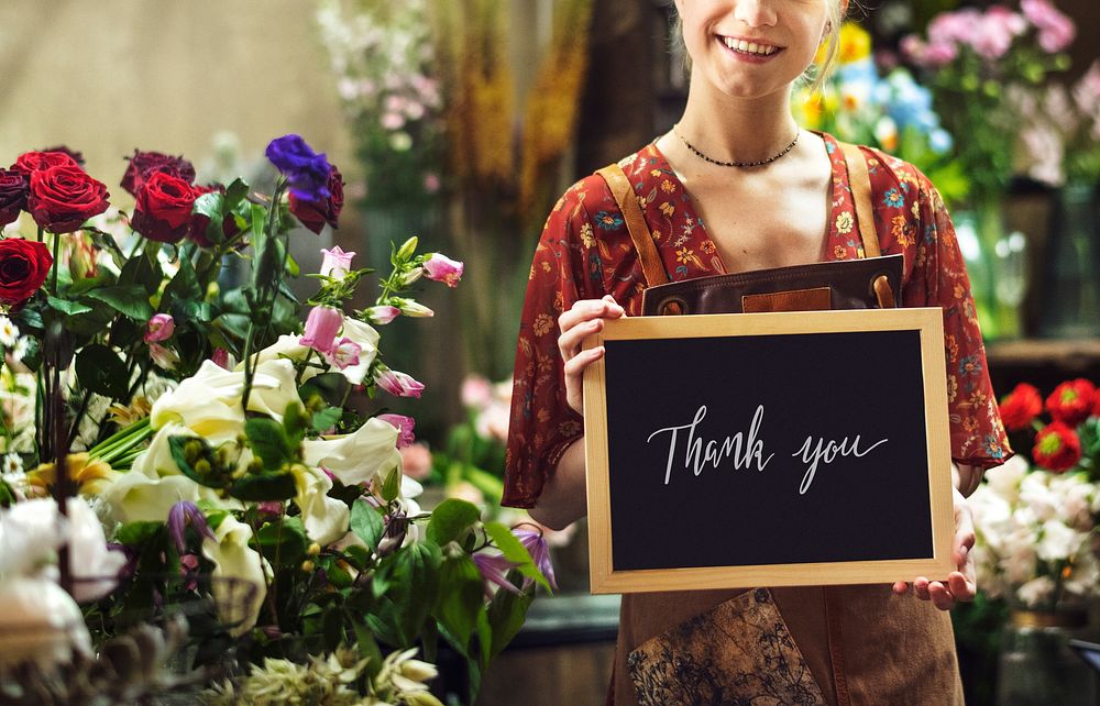 Florist holding a thank you board sign mockup