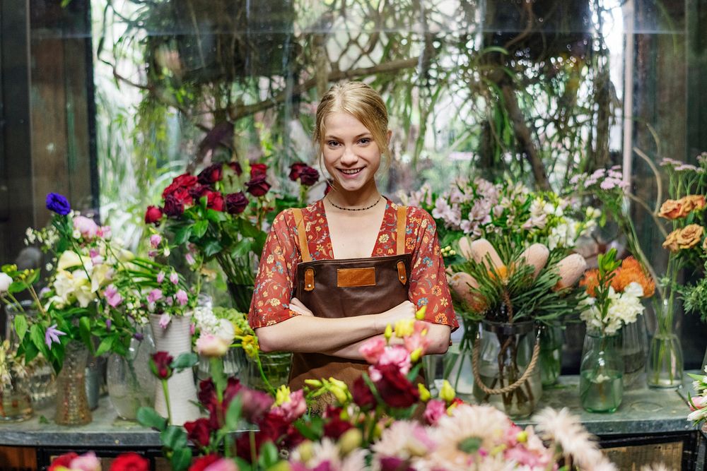 Happy florist in her flower shop