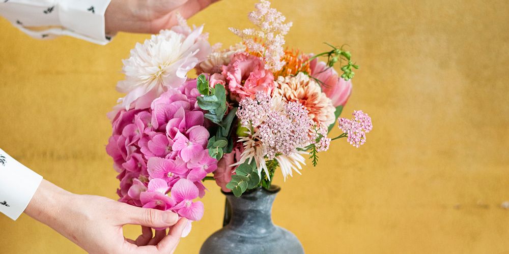 Woman arranging flowers in a vase