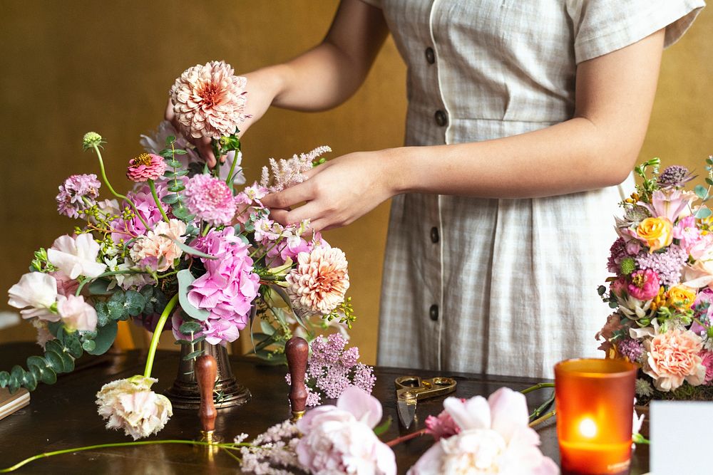 Woman putting a pip salmon in a vase