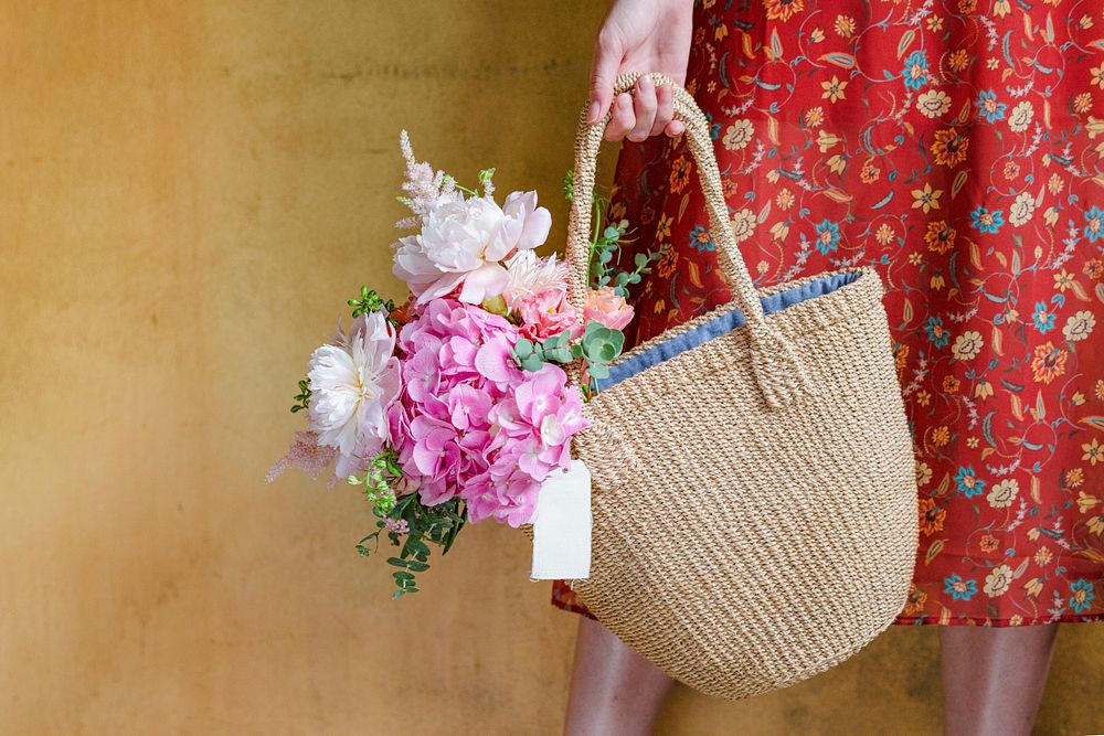 Woman carrying flowers in a wicker bag