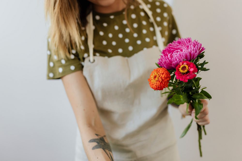 Blond woman making a bouquet of flowers