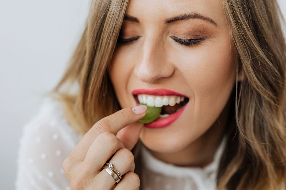 Woman eating a green grape