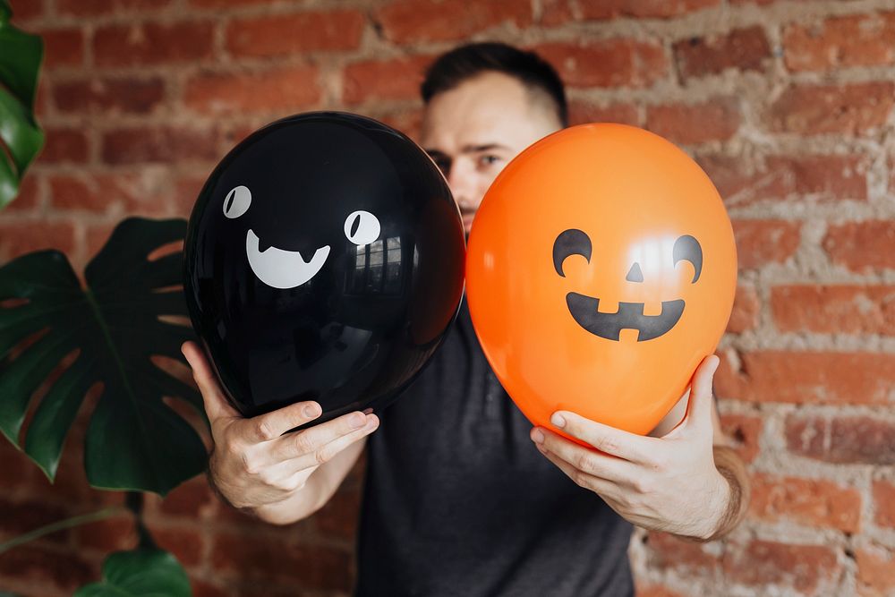 Man with cute Halloween balloons