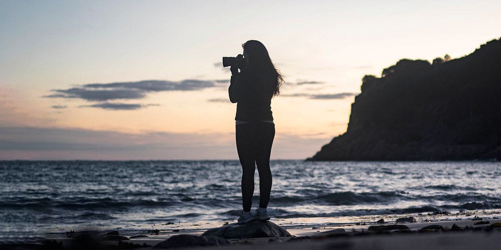Female photographer capturing the sunset at Portelet Bay, Isle of Jersey