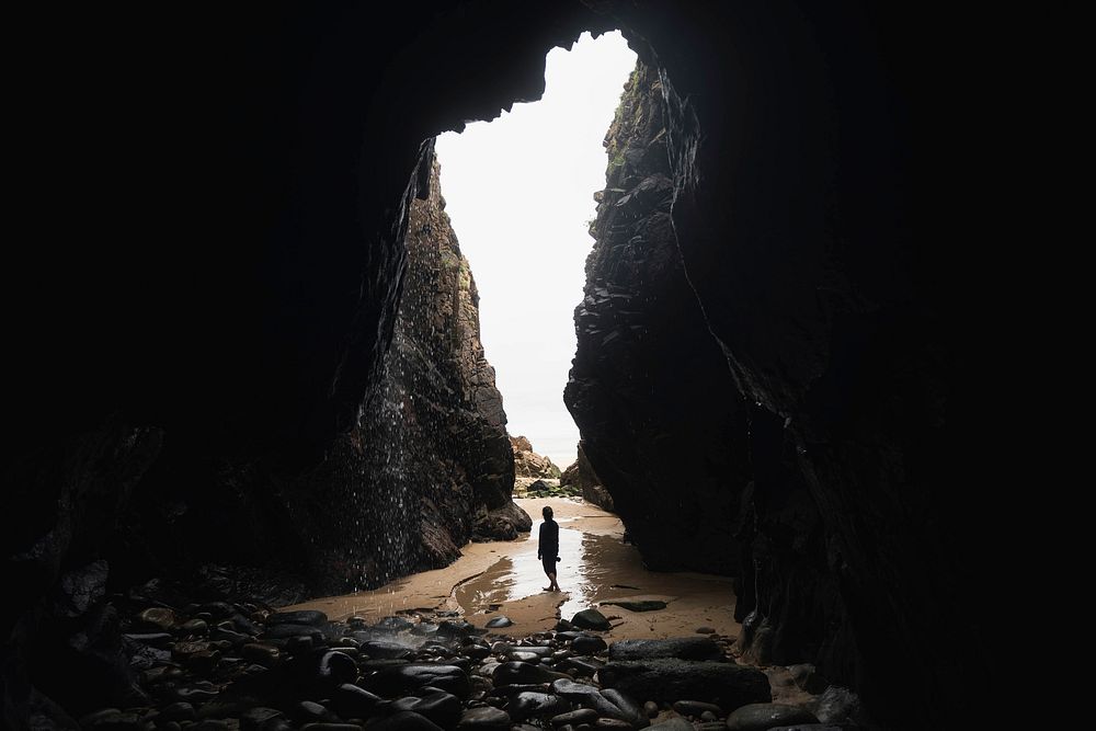 Female photographer in a cave by the beach at the Channel Islands
