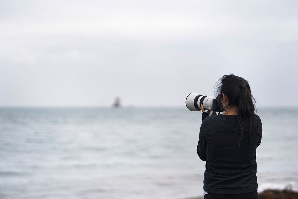 Female photographer capturing Seymour Tower, Channel Islands