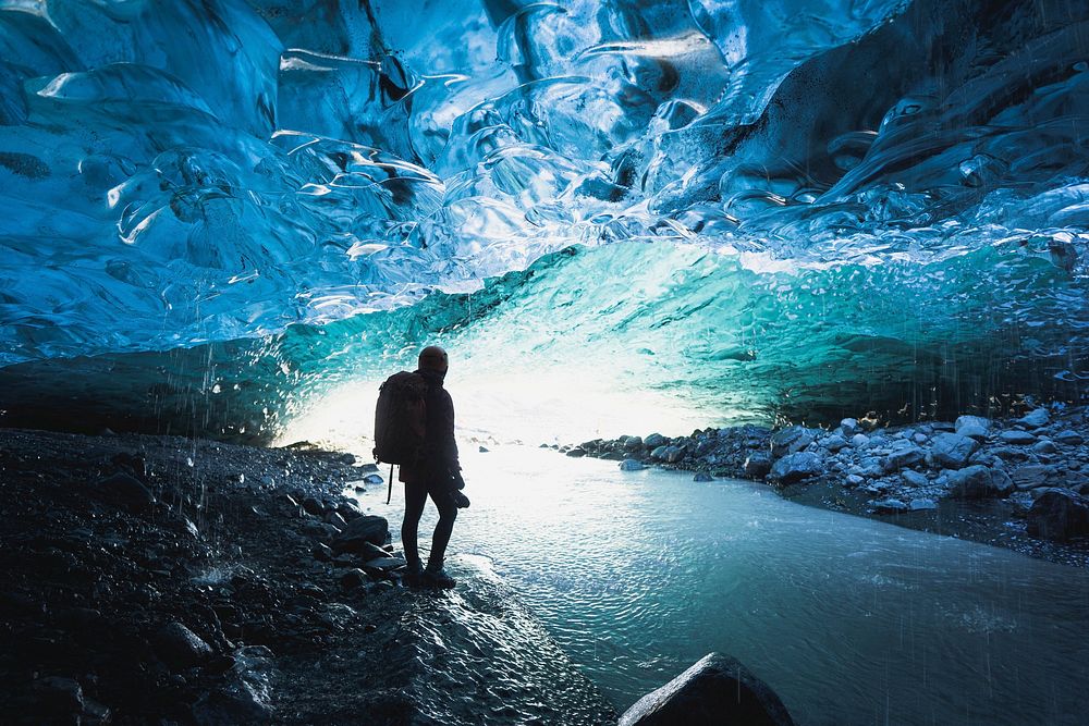 Female photographer in the ice cave, Iceland