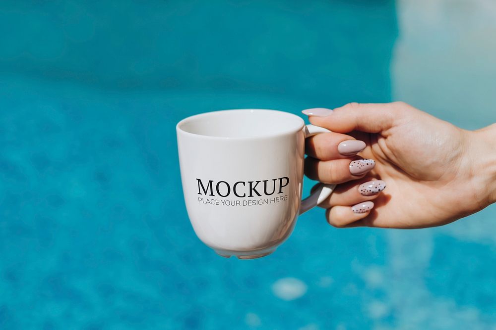 Woman holding a white coffee cup by the pool mockup