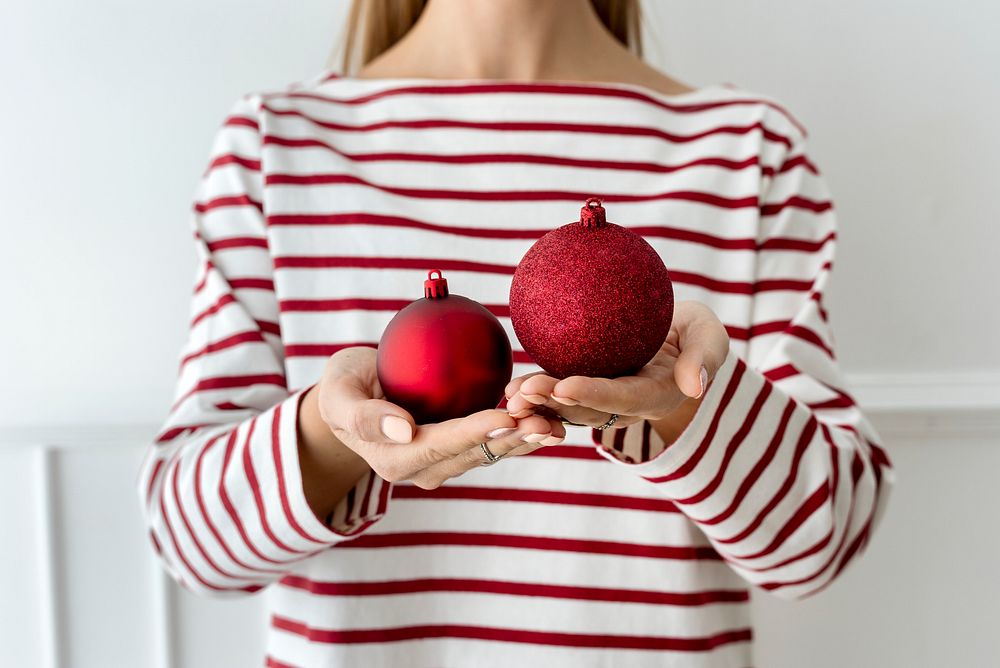 Woman holding a red bauble
