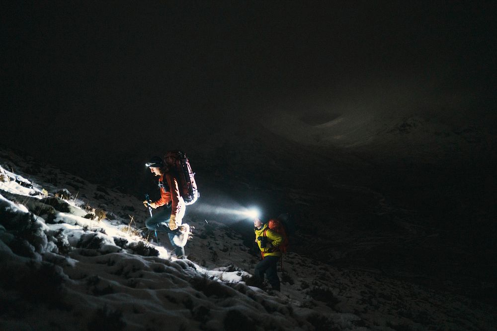 Mountaineers trekking in the cold night at Glen Coe, Scotland