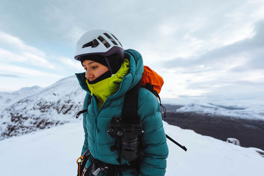 Mountaineer climbing in the snow at Liathach Ridge, Scotland