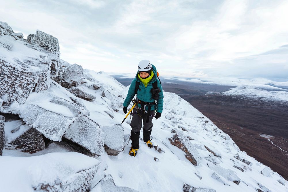Mountaineer climbing in the snow at Liathach Ridge, Scotland