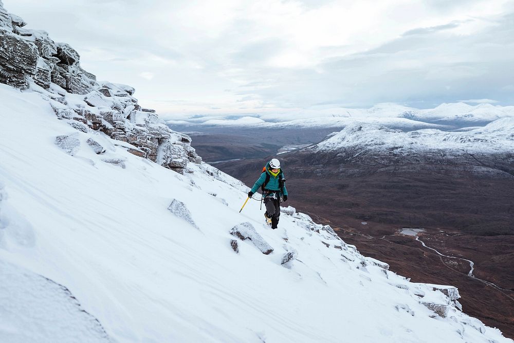 Mountaineer climbing in the snow at Liathach Ridge, Scotland