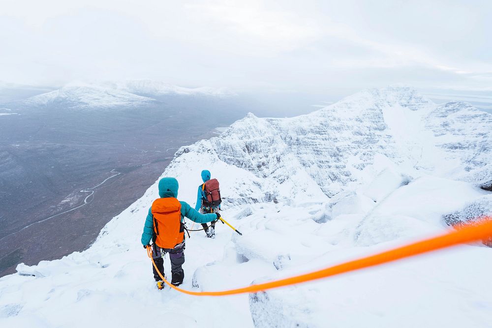 Mountaineers climbing a snowy Liathach Ridge in Scotland