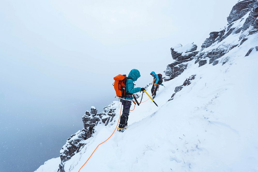 Mountaineers climbing a snowy Liathach Ridge in Scotland