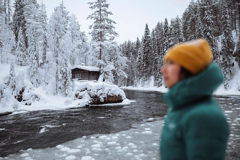 Woman at a frozen river in Lapland, Finland