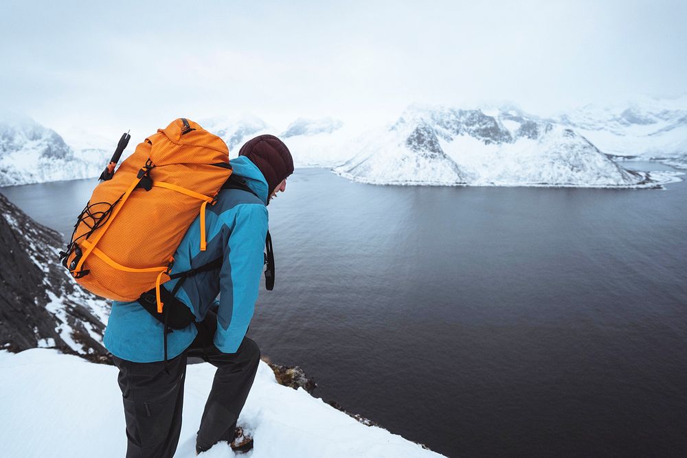 Backpacker hiking up Segla mountain in Norway