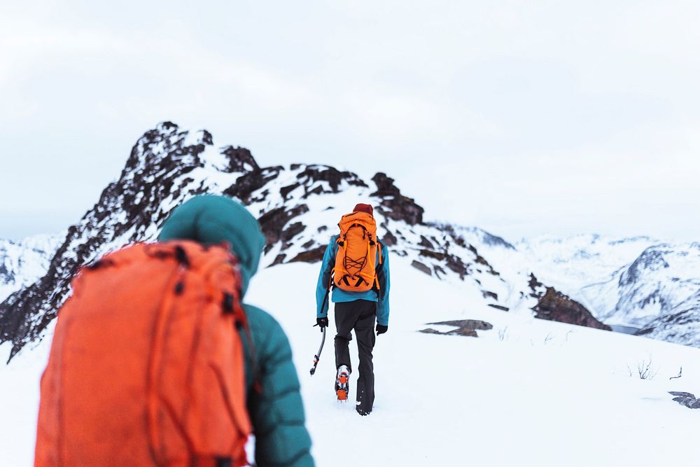 Backpackers hiking up Segla mountain, Norway