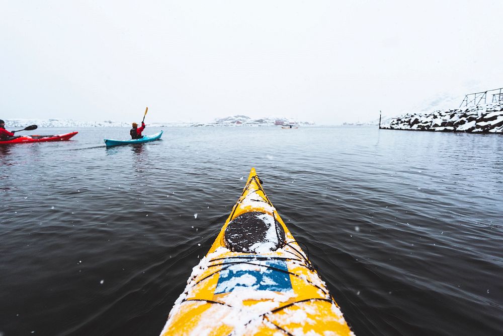 Woman paddling the kayak in Lofoten, Norway