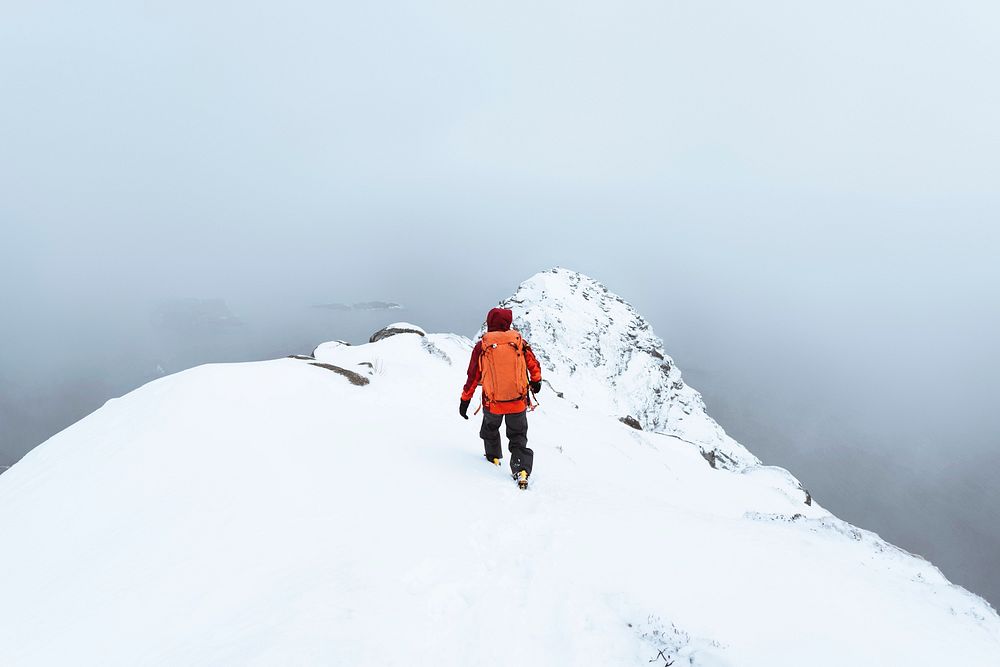 Hiker up in Reinebringen in the Lofoten Islands, Norway