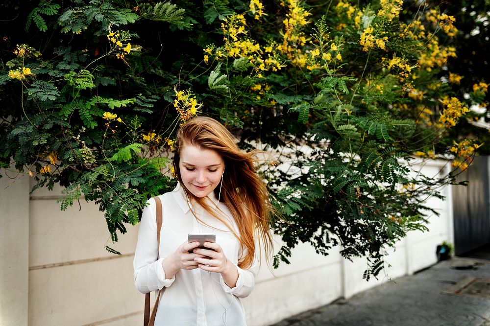 Young caucasian woman is using mobile phone