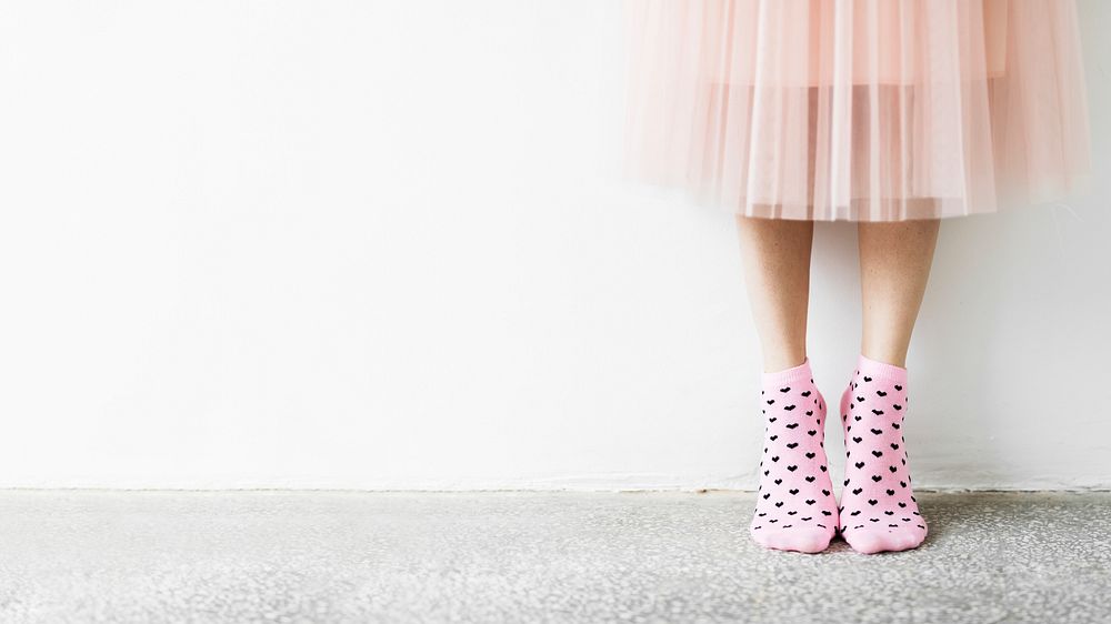 Woman in a skirt wearing pink socks wallpaper