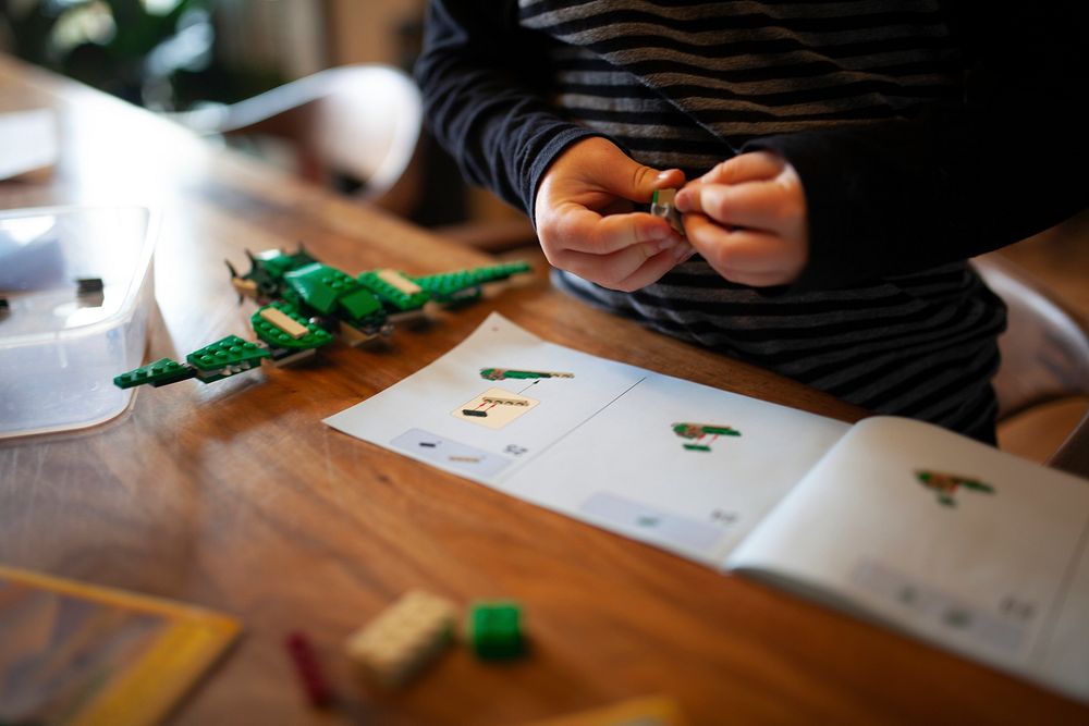 Kid building aircraft with brick toy education photo