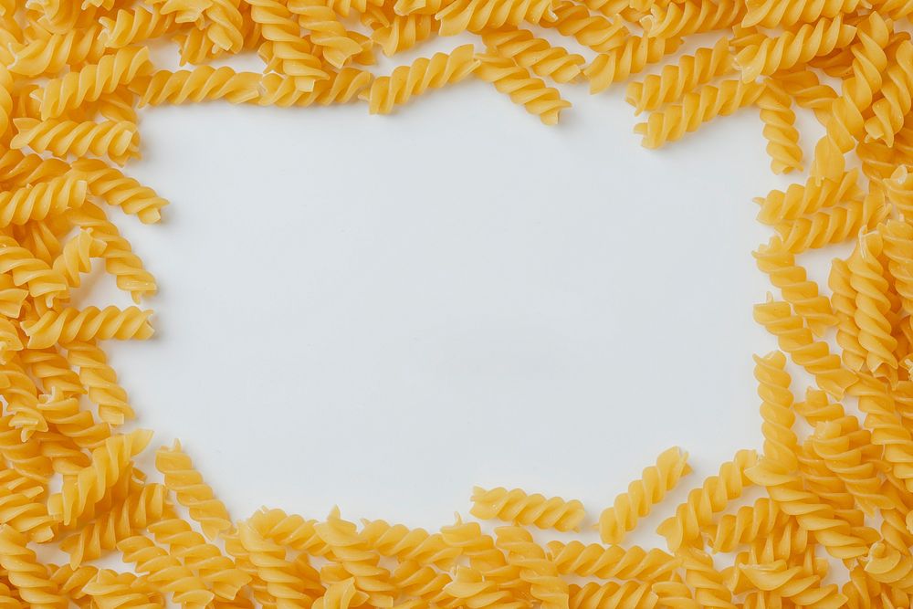 Uncooked fusili pasta frame on white