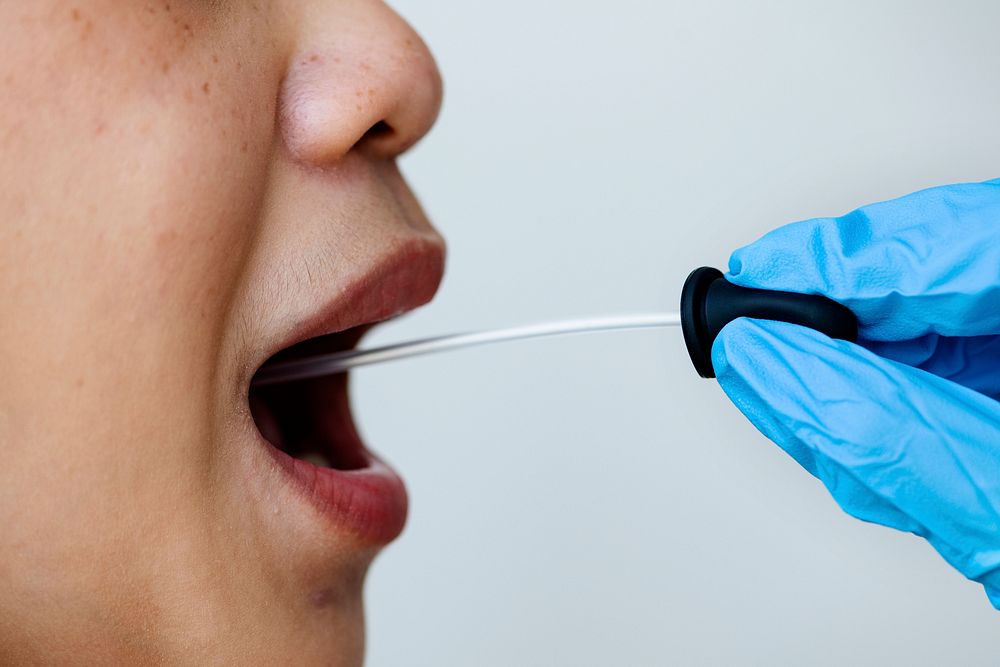 Woman getting a mouth swab to test for coronavirus
